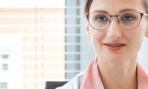 Doctor woman handing slip for prescription drug over to patient